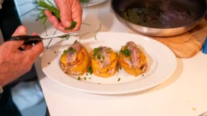 ajout des herbes sur millefeuille de pommes de terre et de sardines